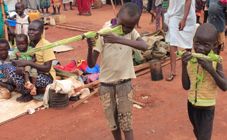 Image: Martin Andrea and a friend play with toy guns made from long grass reeds at a displaced persons camp protected by U.N. peacekeepers in Wau, South Sudan