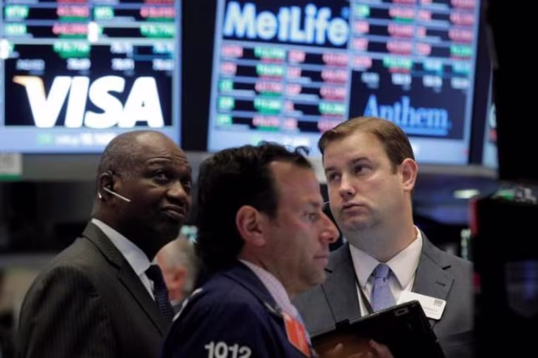 Traders work on the floor of the NYSE