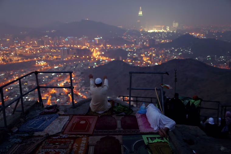 Image: A pilgrim prays at Mount Al-Noor ahead of the annual haj pilgrimage in the holy city of Mecca