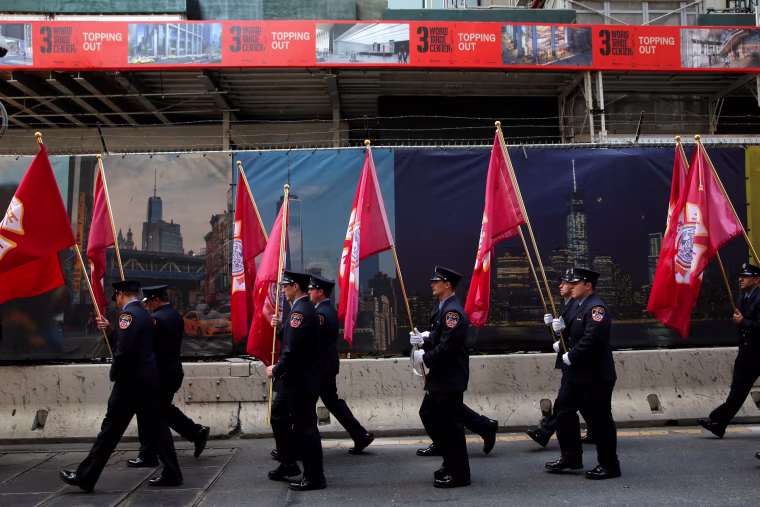 Image: Firefighters arrive for a memorial service at the World Trade Center complex on the morning of the 15th anniversary of the 9/11 attacks in Manhattan, New York