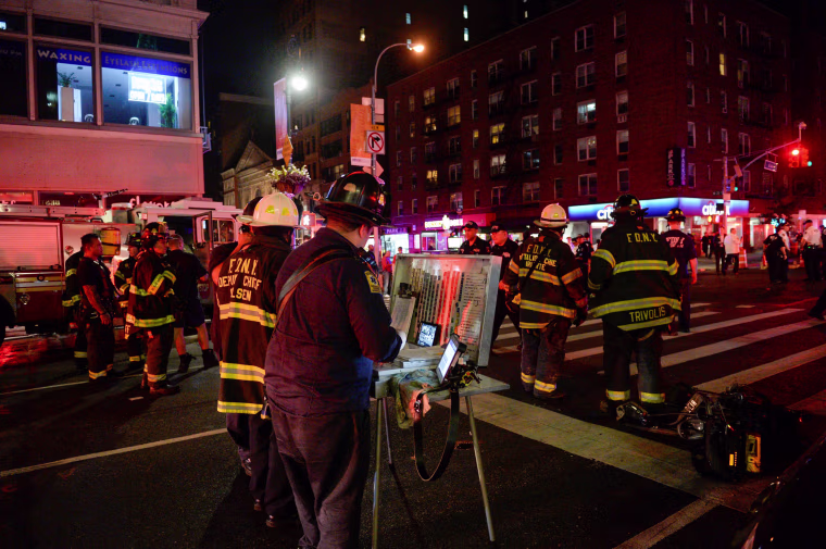 Image: New York City police and firefighters stand near the site of an explosion in the Chelsea neighborhood of Manhattan, New York
