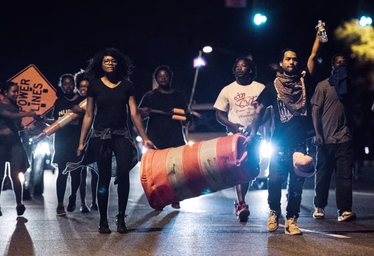 Image: Protesters march down W.T. Harris Blvd