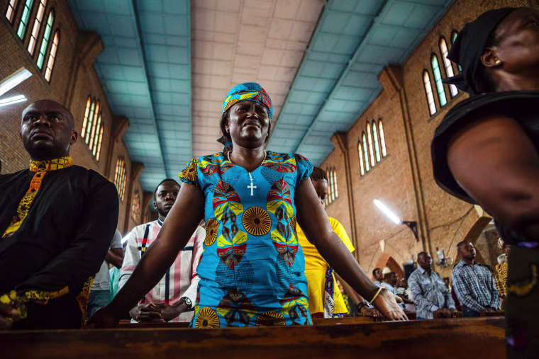 Image: A woman cries as she attends a Catholic mass in Kinshasa