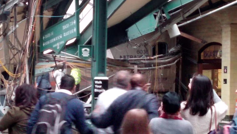 Image: Onlookers view a New Jersey Transit train that derailed and crashed through the station in Hoboken, New Jersey,