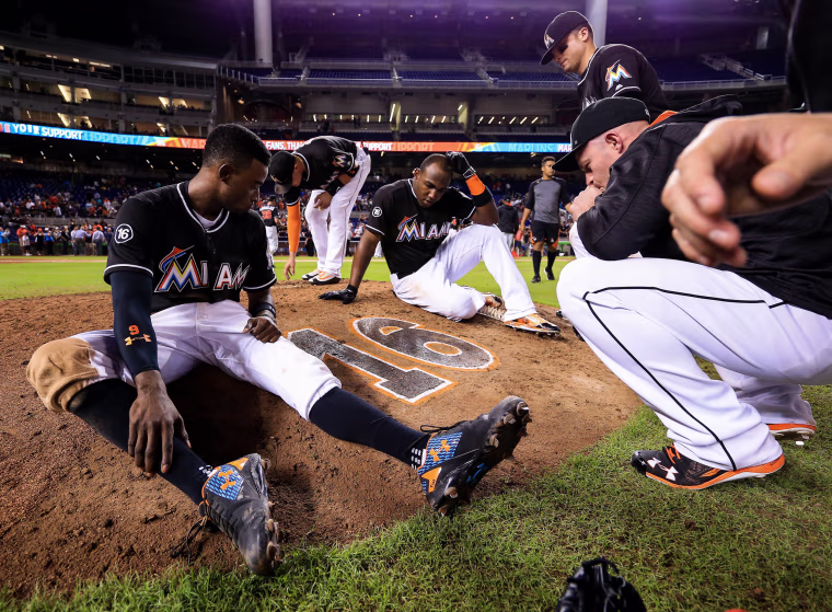 Image: Members of the Miami Marlins gather around the number of star pitcher Jose Fernandez on the pitching mound