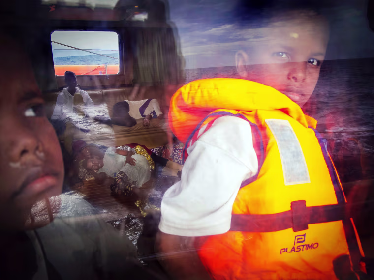 Image: Eight-year-old Samir from Somalia looks out of the window of the Astral rescue ship