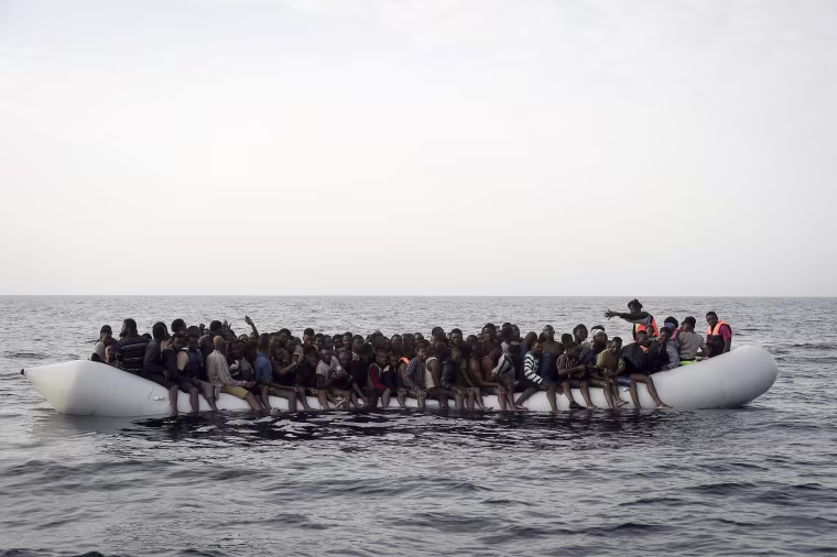 Image: Migrants wait to be rescued by members of Proactiva Open Arms NGO