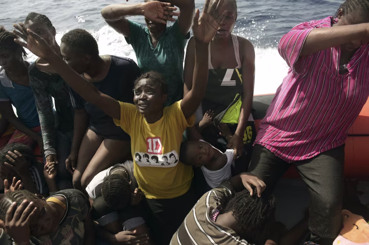 Image: Migrants react as they are being rescued by members of Proactiva Open Arms NGO