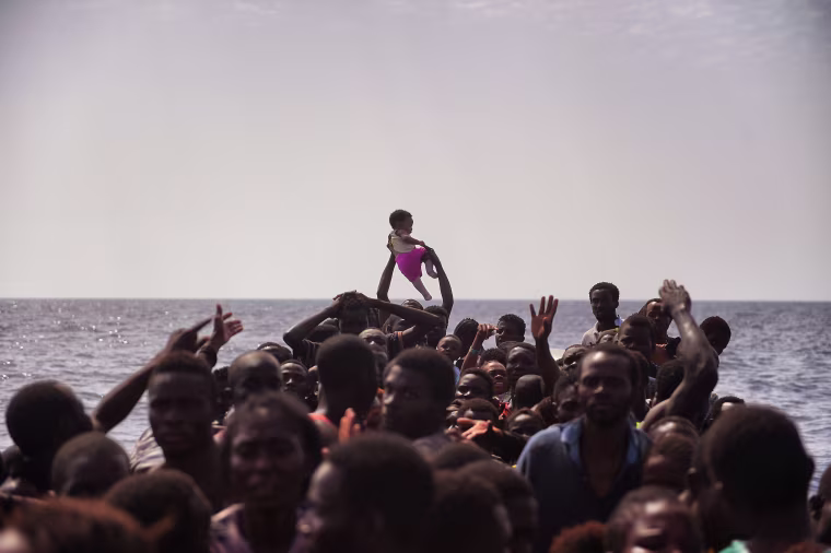 Image: Migrants wait to be rescued by members of Proactiva Open Arms NGO