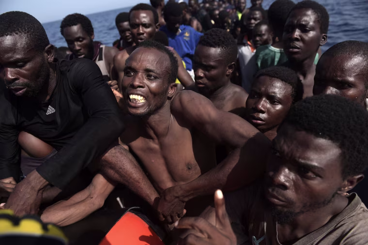 Image: Migrants wait to be rescued by members of Proactiva Open Arms NGO