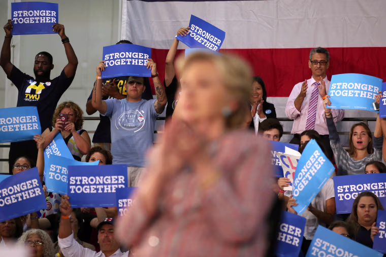 Image: Supporters listen to U.S. Democratic presidential nominee Clinton and former Vice President Al Gore talk about climate change at a rally at Miami Dade College in Miami