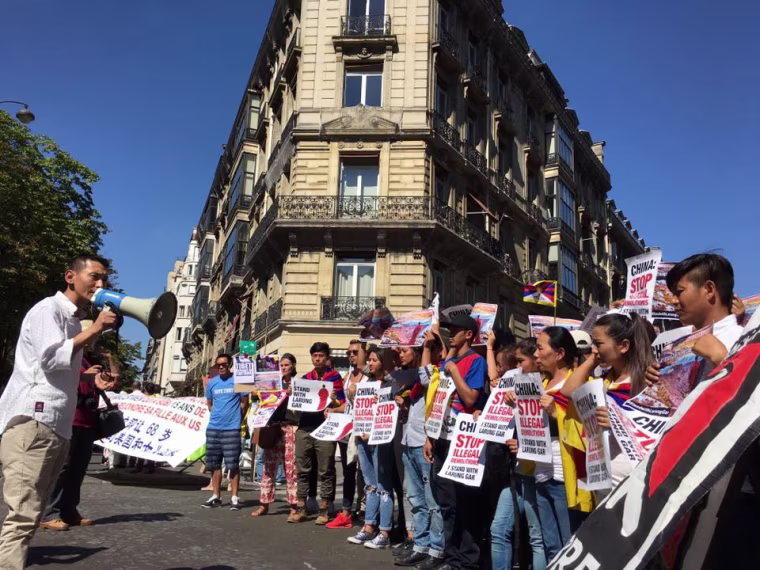 Dhondup Phuntsok, president of Students for a Free Tibet in France, addresses a group of protesters through the megaphone, in a photo dated Aug. 17, 2016.