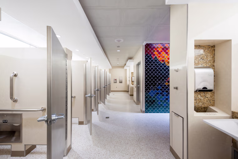 As part of a multi-year program to renovate more than 100 sets of restrooms at Minneapolis-St. Paul International Airport, the new bathrooms are lined with artist-made mosaics. 