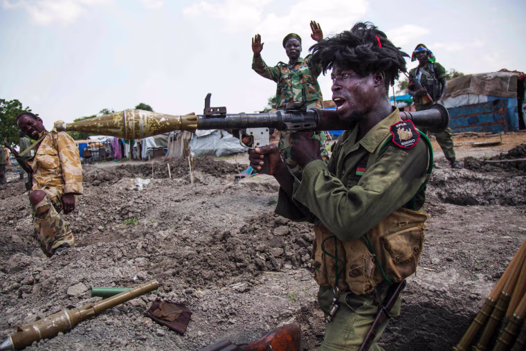 Image: Soldiers of the Sudan People Liberation Army (SPLA) celebrate while standing in trenches in Lelo