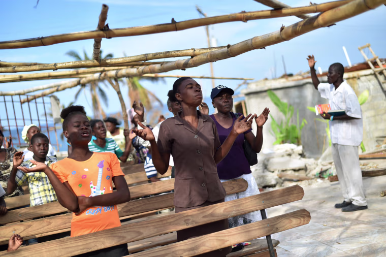 Image: Members of an evangelic church attend church damaged by Hurricane Matthew in Les Cayes, Haiti