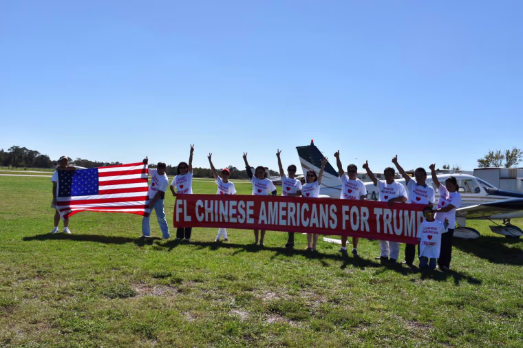 Members of Chinese Americans for Trump with a banner in the state of Florida.