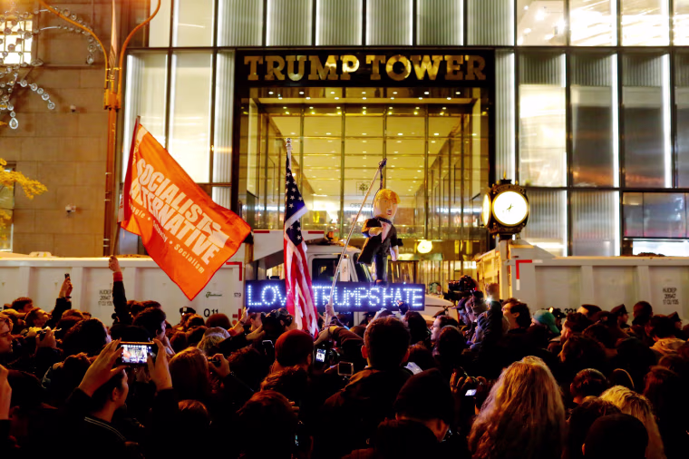 Image: Protesters reach Trump Tower as they march against Republican president-elect Donald Trump in the neighborhood of Manhattan in New York