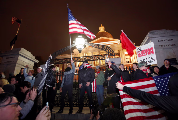 Image: Protesters stand on the state house steps during a march in opposition to the election of Republican Donald Trump as President of the United States in Boston