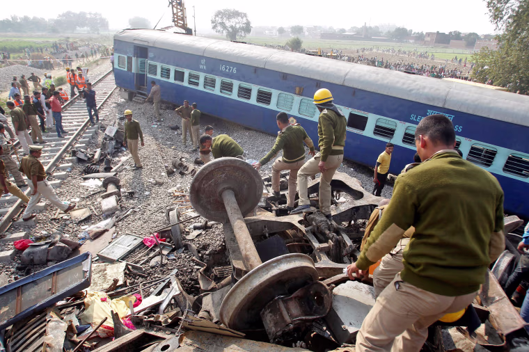 Image: Rescue workers search for survivors at the site of a train derailment in Pukhrayan, south of Kanpur city, India