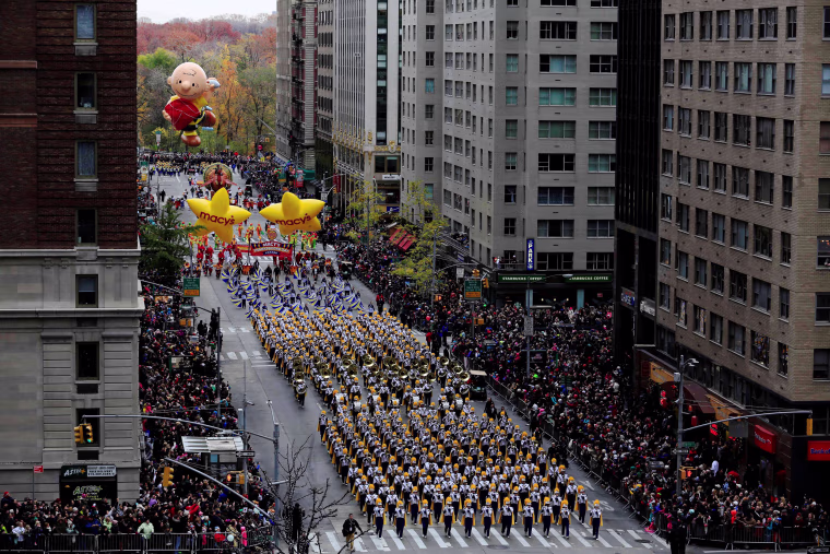 Image: A marching band makes its way down 6th Avenue during the 90th Macy's Thanksgiving Day Parade in the Manhattan borough of New York