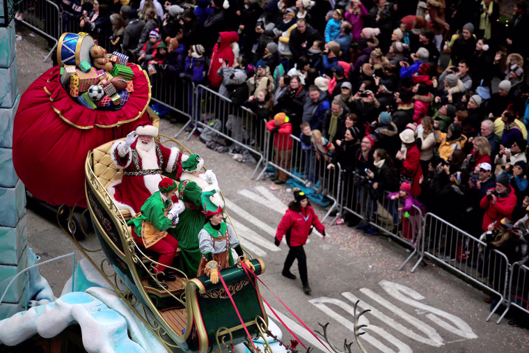 Image: A Santa Claus makes its way down 6th Avenue during the 90th Macy's Thanksgiving Day Parade in the Manhattan borough of New York