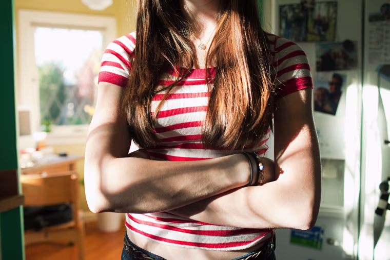 Teenage girl with arms crossed