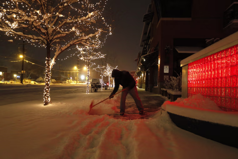 Image: Rick Velasquez shovels fresh snow during a winter storm in Boulder