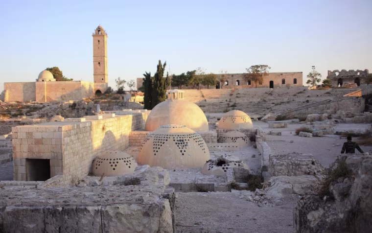 Image: A general view shows damage at Aleppo's historic citadel in 2014