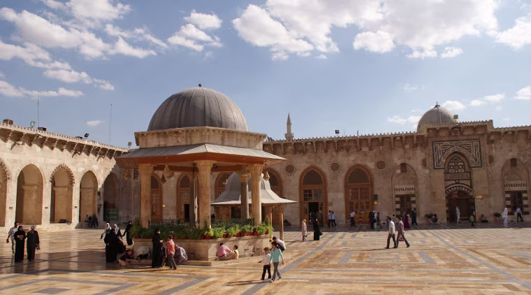 Image: Visitors walk inside Aleppo's Umayyad mosque in 2010
