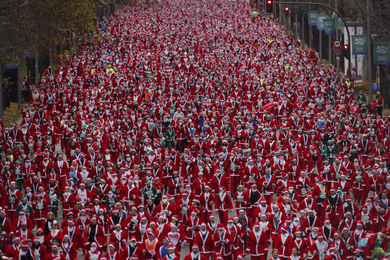 Image: People dressed in Santa Claus costumes take part in a run in Madrid, Dec. 17, 2016.