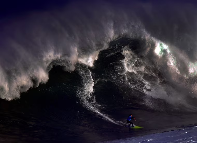 Image: A surfer rides a large wave at El Bocal during the Vaca Gigante giant wave surf competition in Santander