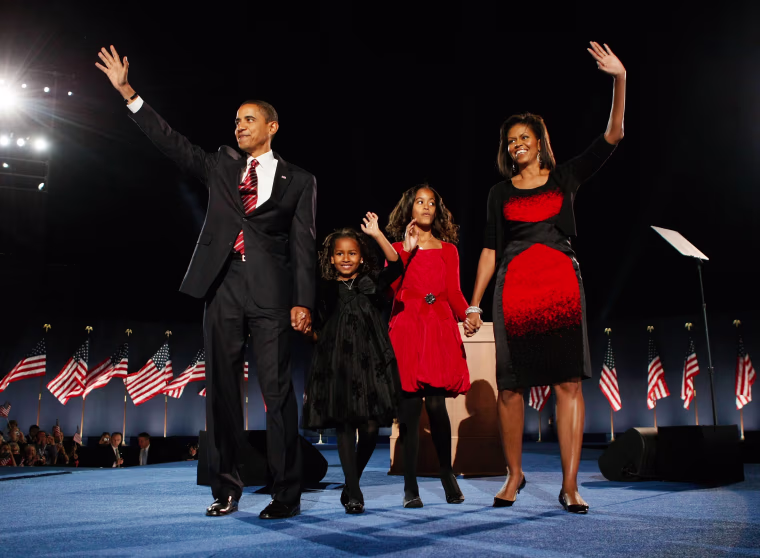 Image: President elect Barack Obama stands on stage along with his wife Michelle and daughters Malia (red dress) and Sasha (black dress) during an election night gathering in Grant Park on Nov. 4, 2008 in Chicago, Ill.