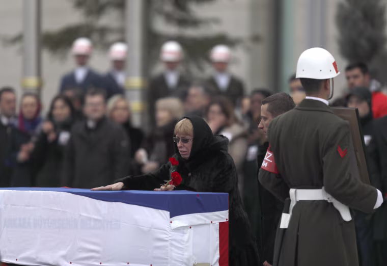 Image: Late Russian Ambassador to Turkey Andrei Karlov's wife Marina reacts next to the flag-wrapped coffin during a ceremony at Esenboga airport in Ankara, Turkey, Dec. 20.
