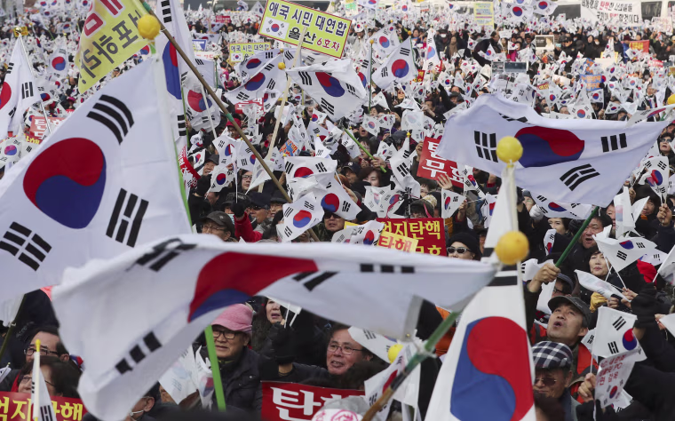 Image: Amid rallies demanding the president's removal, her supporters waved national flags.
