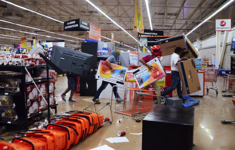 Image: Dozens of people loot shops during an alleged protest against the increase in the gas prices, in the port of Veracruz, Mexico on Jan. 4.