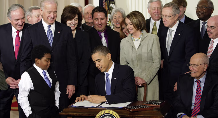 Image: President Barack Obama signs the health care bill in the East Room of the White House