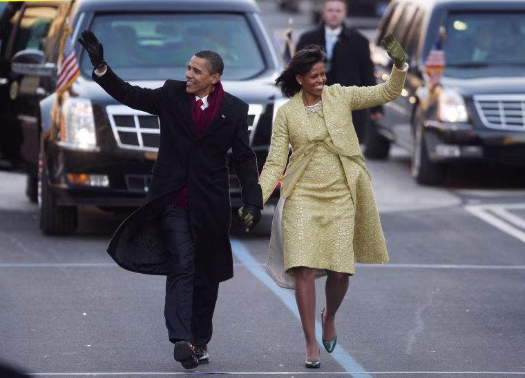 Image: Barack and Michelle Obama walk down Pennsylvania Avenue in Washington