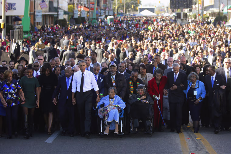Image: Obama participates in a march across the Edmund Pettus Bridge in Selma, Alabama