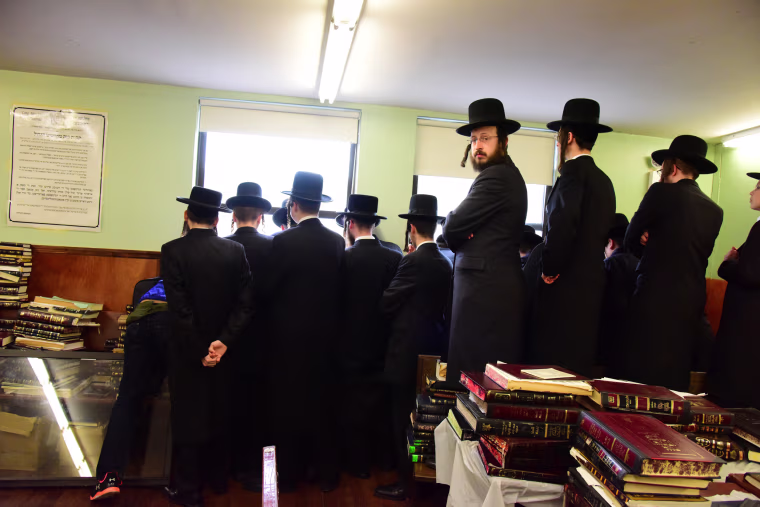 Students watch funeral from second floor of yeshiva.