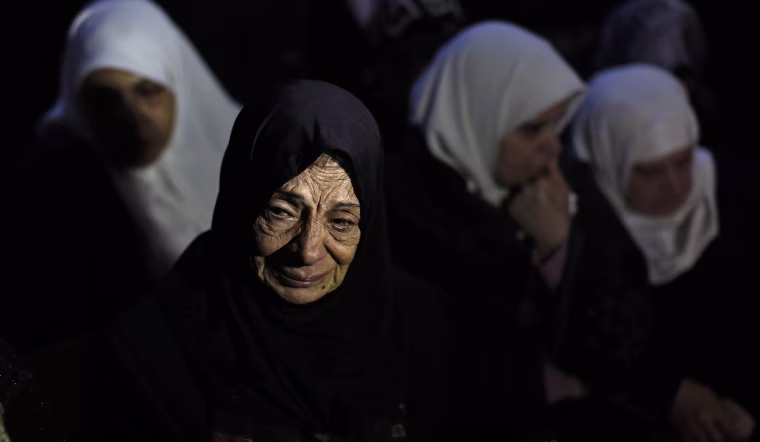 Image: Unidentified relatives of Mohamed al-Salihi react during his funeral at Al-Faraa Refugee Camp near the West Bank city of Nablus, Jan. 10.