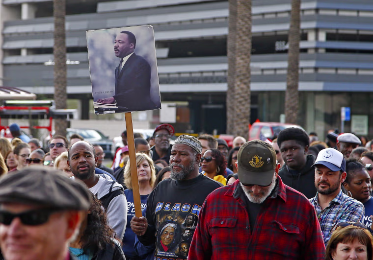 Image: Participants walk during a Martin Luther King Jr. Day march on Jan. 16 in Phoenix, Arizona.