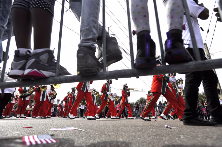 Image: Children stand on the parade route railings to watch Jones High School Marching band perform during the Martin Luther King Jr., Day parade in Tampa, Florida on Jan. 16.