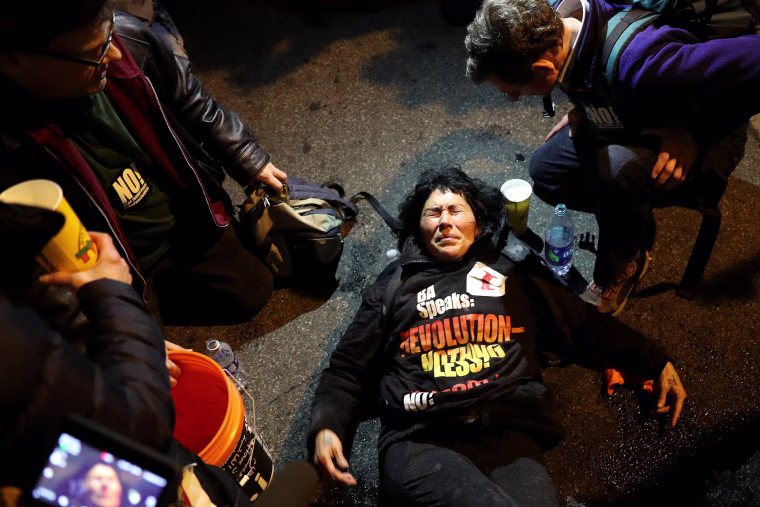 Image: A protester has her eyes doused with water after being pepper sprayed by police outside of the DeploraBall at the National Press Building on Jan. 19, 2017 in Washington, D.C.