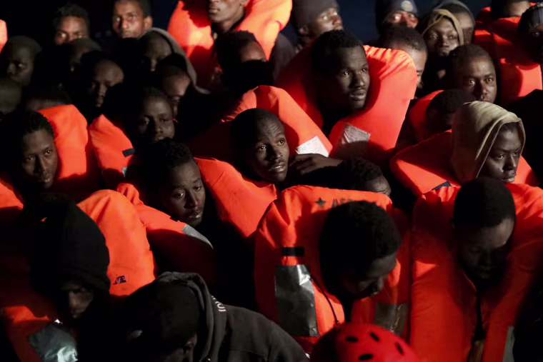 Image: Migrants are aboard an overcrowded raft as the former fishing trawler Golfo Azzurro of the Spanish NGO Proactiva Open Arms approaches during a rescue operation, in the central Mediterranean Sea, 24 miles north of the Libyan coastal city of Sabratha