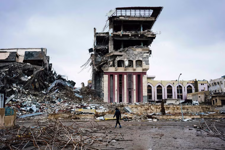 Image: An Iraqi man walks outside Mosul's University