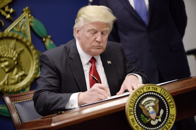 Image: President Donald Trump signs Executive Orders in the Hall of Heroes at the Pentagon in Arlington, Virginia on Jan. 27.