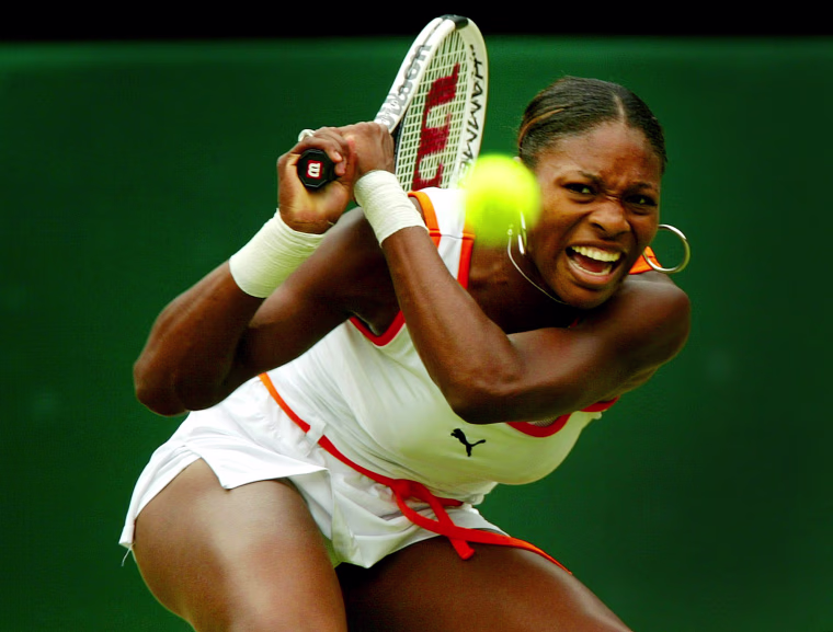 Image: 2003: Serena Williams returns to her sister Venus during their women's singles final match at the Wimbledon Tennis Championships in London on July 5. Serena defeated Venus.