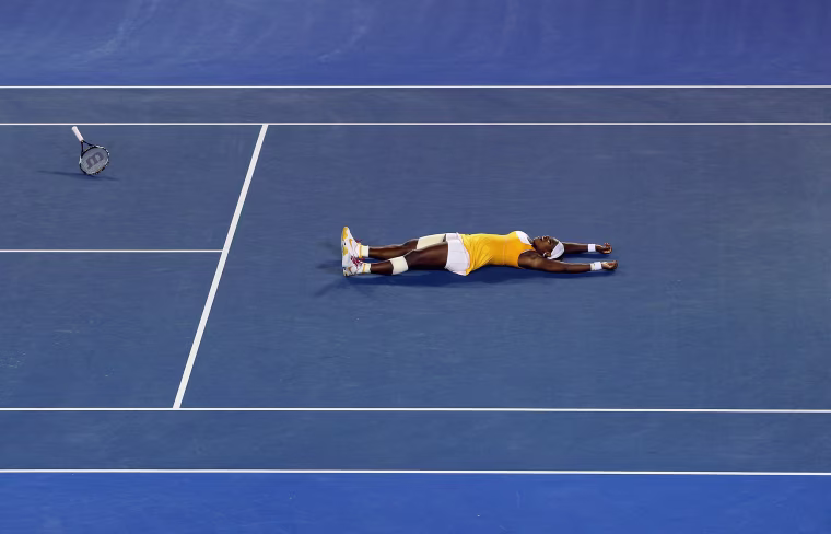 Image: 2010: Serena Williams throws her racquet into the air after winning the women's final match against Justine Henin of Belgium during the 2010 Australian Open in Melbourne, Australia on Jan. 30.