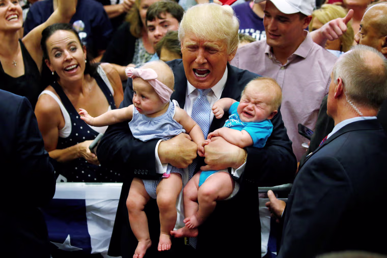 Image: Republican presidential nominee Donald Trump holds babies at a campaign rally in Colorado Springs,
