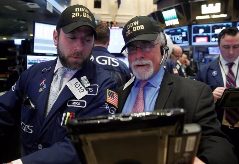 Traders work on the main trading floor of the NYSE as the Dow Jones Industrial Average passes 20,000 after opening of trading session in New York